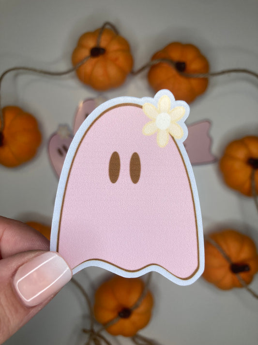 Pink ghost sticker in front of pumpkins